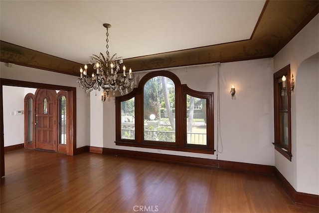 101 S Windsor Blvd, Los Angeles, CA 90004 - unfurnished dining area featuring baseboards, wood finished floors, a chandelier, and arched walkways