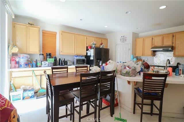 15541 Bow String St, Victorville, CA 92394 - kitchen featuring light brown cabinets, stainless steel appliances, tile counters, under cabinet range hood, and recessed lighting