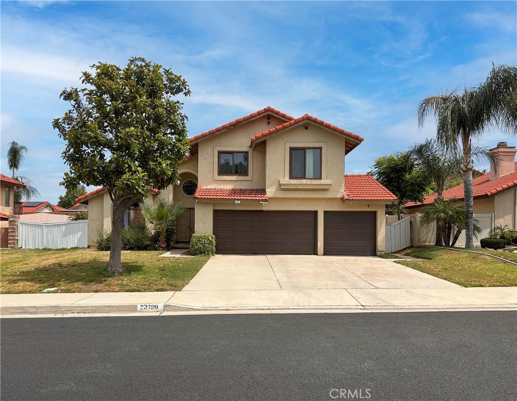 23790 Redbark Dr, Moreno Valley, CA 92557 - mediterranean / spanish-style home with a tile roof, a garage, driveway, and stucco siding