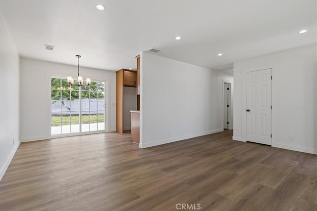 45433 Lorimer Ave, Lancaster, CA 93534 - empty room featuring a chandelier, wood finished floors, baseboards, and recessed lighting
