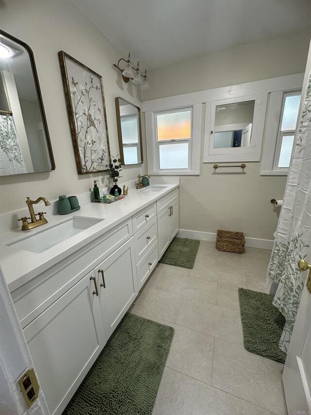 2453 Curlew St, San Diego, CA 92101 - bathroom with double vanity, baseboards, and tile patterned flooring