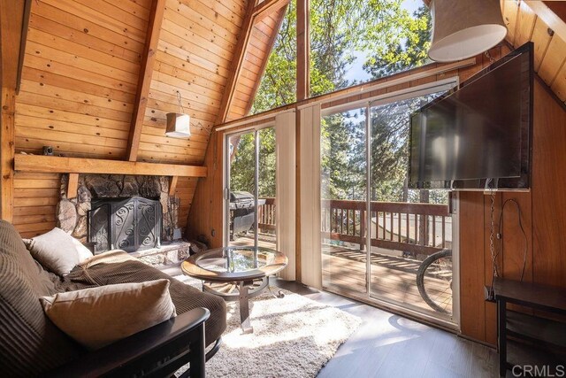 31450 Oceanview Dr, Running Springs, CA 92382 - living area featuring vaulted ceiling, a fireplace, wood finished floors, and wooden walls