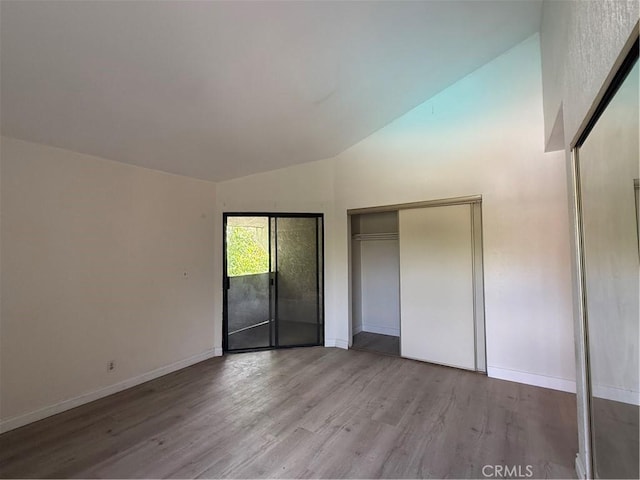 1701 Garvey Ave Unit 9, Alhambra, CA 91803 - unfurnished bedroom with wood finished floors, baseboards, and high vaulted ceiling