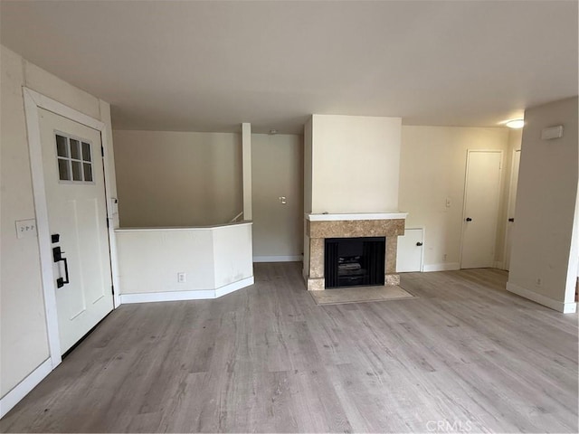 1701 Garvey Ave Unit 9, Alhambra, CA 91803 - unfurnished living room featuring wood finished floors, a tiled fireplace, and baseboards