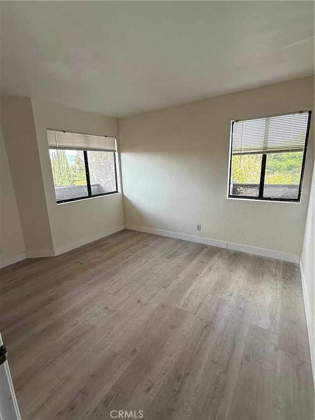 1701 Garvey Ave Unit 9, Alhambra, CA 91803 - empty room with wood finished floors, healthy amount of natural light, and baseboards