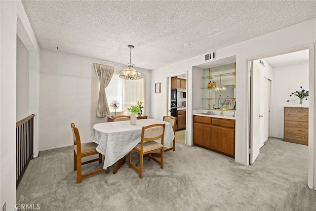 422 S Alhambra Ave Unit A, Monterey Park, CA 91755 - dining area with light colored carpet, a chandelier, and a textured ceiling