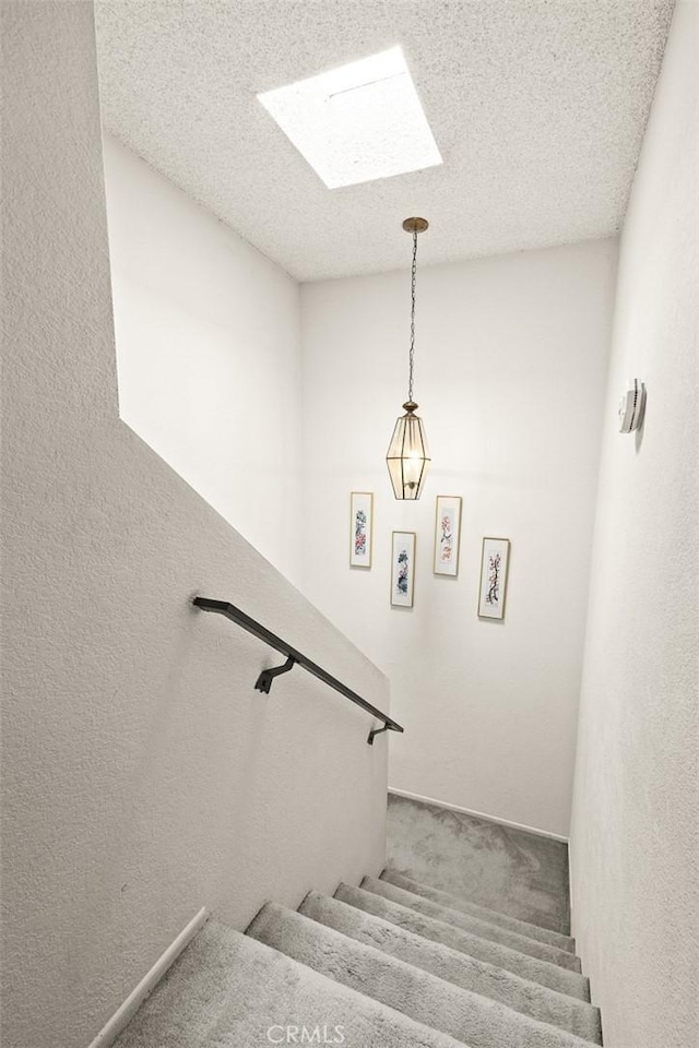 422 S Alhambra Ave Unit A, Monterey Park, CA 91755 - stairway featuring a skylight, carpet flooring, and a textured ceiling
