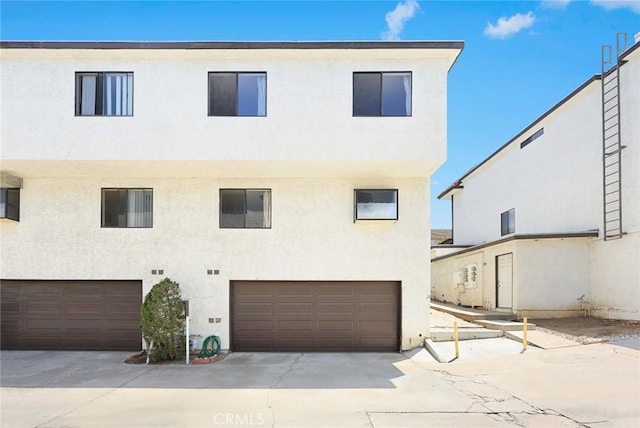 422 S Alhambra Ave Unit A, Monterey Park, CA 91755 - rear view of property with stucco siding and an attached garage