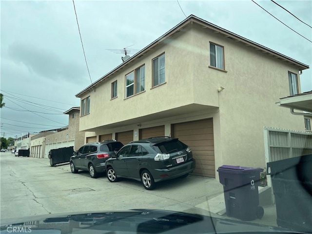 1110 E Carson St, Long Beach, CA 90807 - view of side of home with stucco siding and an attached garage