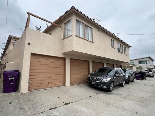 1110 E Carson St, Long Beach, CA 90807 - view of front facade with stucco siding, an attached garage, and concrete driveway