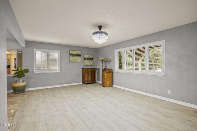 1099 N Agusta Ave, Camarillo, CA 93010 - unfurnished living room with wood finished floors and a chandelier