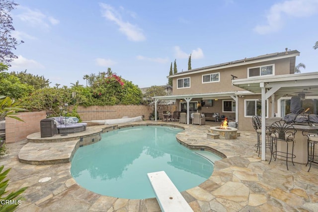 1099 N Agusta Ave, Camarillo, CA 93010 - view of pool featuring a patio area, a diving board, a fenced backyard, and an outdoor living space with a fire pit