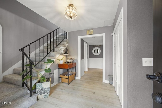1099 N Agusta Ave, Camarillo, CA 93010 - staircase with wood finished floors, a chandelier, and arched walkways