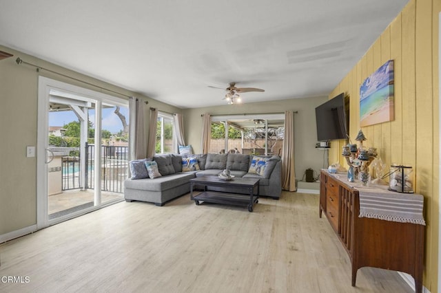 1099 N Agusta Ave, Camarillo, CA 93010 - living area with light wood-type flooring, a ceiling fan, and wood walls