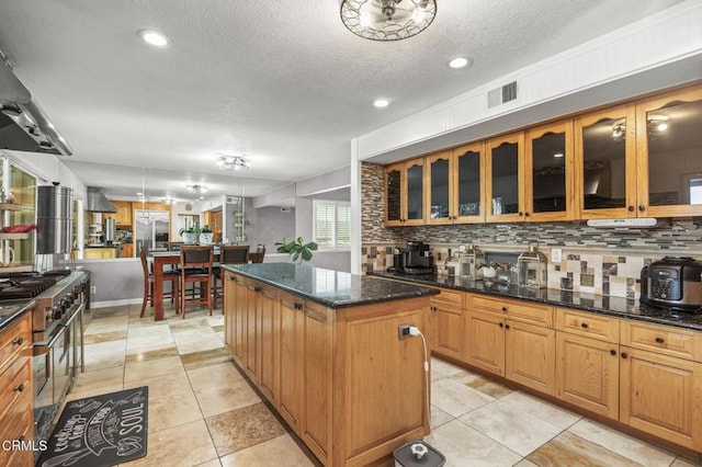 1099 N Agusta Ave, Camarillo, CA 93010 - kitchen featuring high quality appliances, a kitchen island, tasteful backsplash, island exhaust hood, and glass insert cabinets