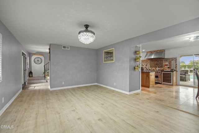 1099 N Agusta Ave, Camarillo, CA 93010 - unfurnished living room featuring light wood-style floors and a chandelier