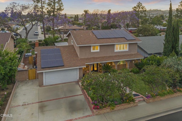 1099 N Agusta Ave, Camarillo, CA 93010 - traditional-style house featuring solar panels, stucco siding, concrete driveway, a porch, and roof with shingles