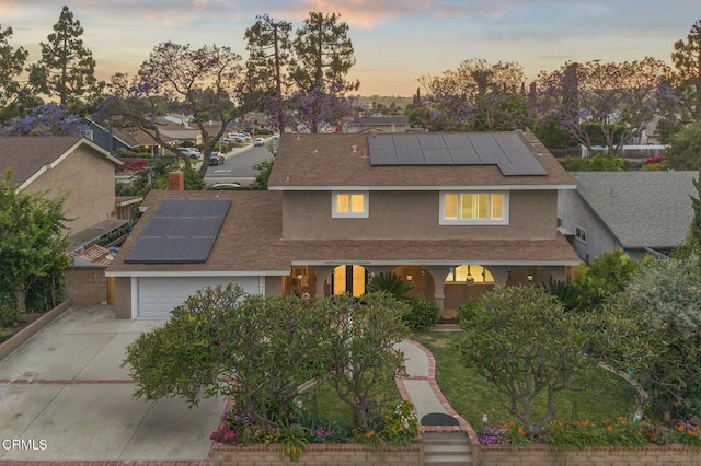 1099 N Agusta Ave, Camarillo, CA 93010 - traditional home with solar panels, stucco siding, covered porch, roof with shingles, and driveway