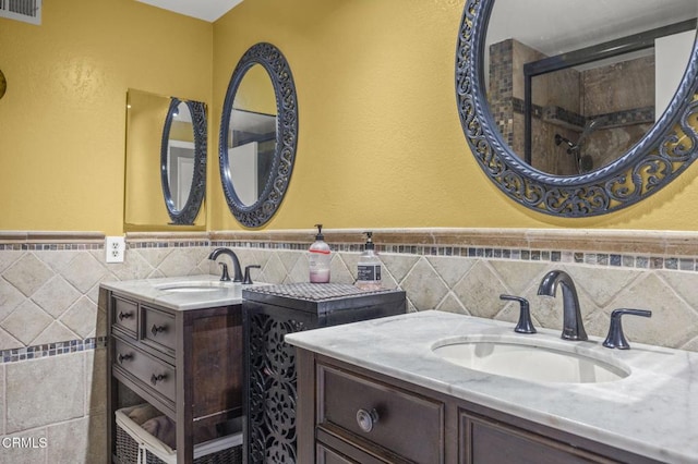 1099 N Agusta Ave, Camarillo, CA 93010 - full bath featuring tile walls, two vanities, wainscoting, and a shower
