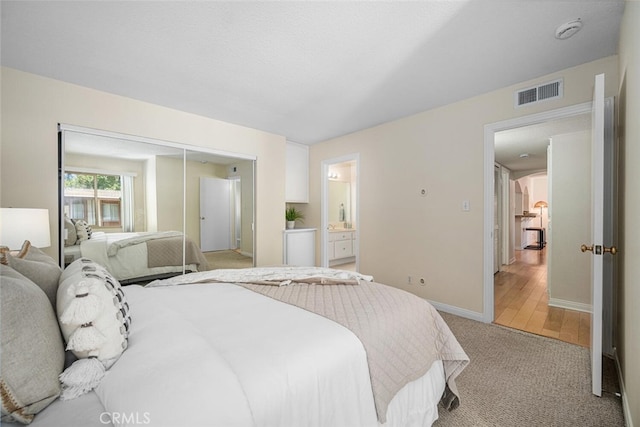 3721 Country Club Dr Unit 18, Long Beach, CA 90807 - bedroom featuring light carpet, ensuite bath, and a closet