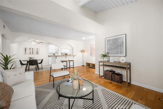 3721 Country Club Dr Unit 18, Long Beach, CA 90807 - living room featuring arched walkways, ceiling fan, and light wood-style floors