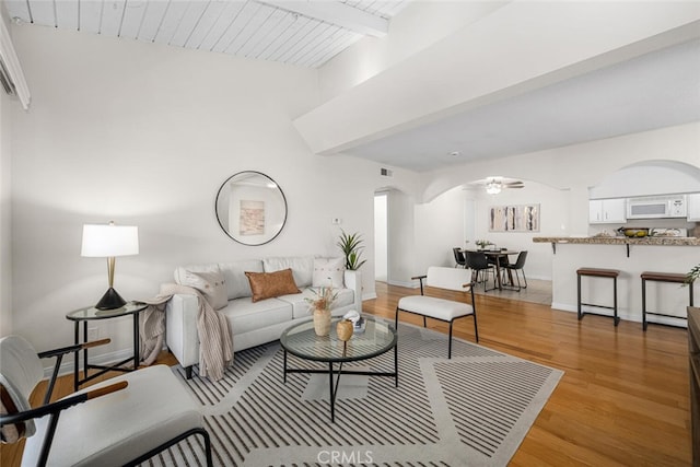 3721 Country Club Dr Unit 18, Long Beach, CA 90807 - living area with arched walkways, beam ceiling, light wood-style flooring, and a ceiling fan