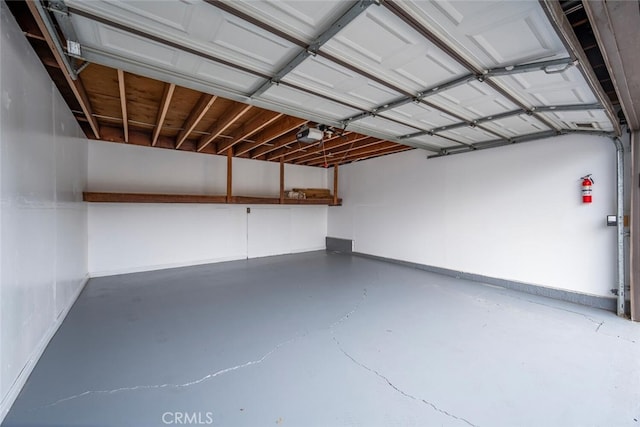 3721 Country Club Dr Unit 18, Long Beach, CA 90807 - garage with baseboards and a garage door opener