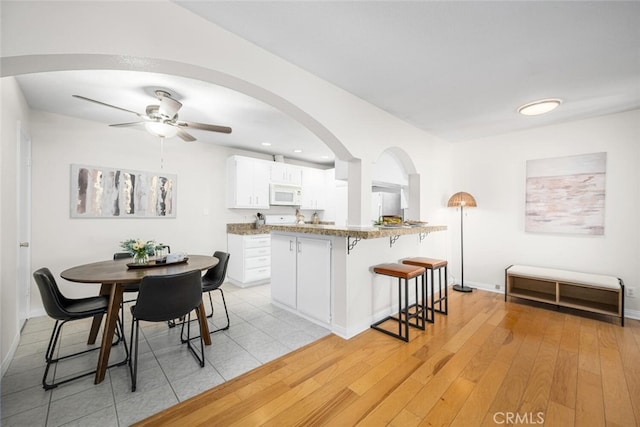 3721 Country Club Dr Unit 18, Long Beach, CA 90807 - dining area with arched walkways, a ceiling fan, light wood finished floors, and recessed lighting