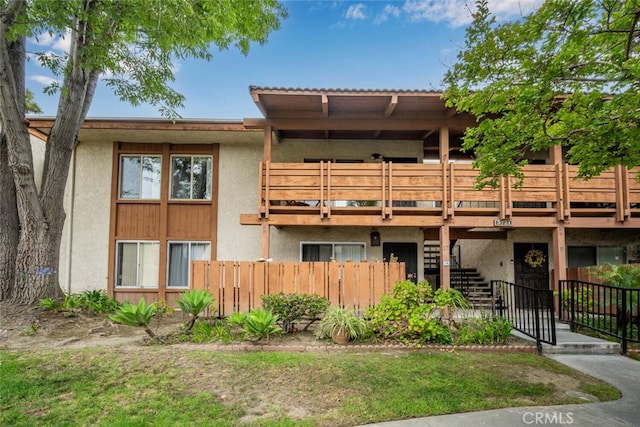 3721 Country Club Dr Unit 18, Long Beach, CA 90807 - back of property with stucco siding, stairway, and a wooden deck