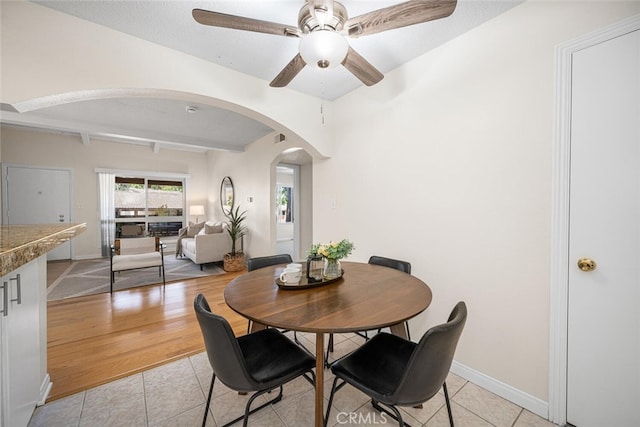 3721 Country Club Dr Unit 18, Long Beach, CA 90807 - dining room featuring arched walkways, light tile patterned floors, ceiling fan, and beamed ceiling