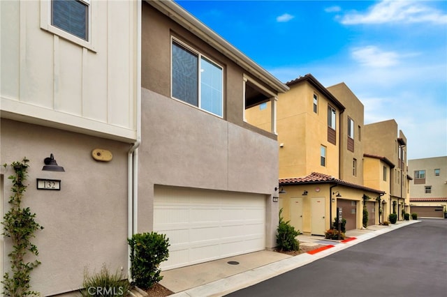 142 Juniper Dr, Rancho Mission Viejo, CA 92694 - view of building exterior featuring a garage and a residential view