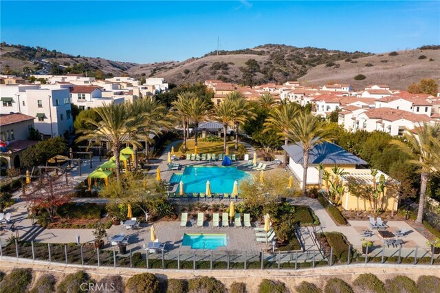 142 Juniper Dr, Rancho Mission Viejo, CA 92694 - aerial view of property's location featuring a pool area, a mountain backdrop, and nearby suburban area