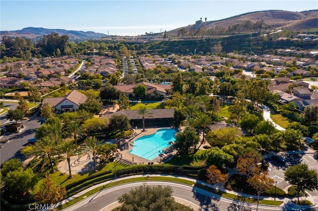 142 Juniper Dr, Rancho Mission Viejo, CA 92694 - aerial overview of property's location with a mountain backdrop, a pool area, and nearby suburban area