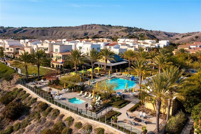 142 Juniper Dr, Rancho Mission Viejo, CA 92694 - aerial view of property and surrounding area featuring a pool, a mountain backdrop, and nearby suburban area