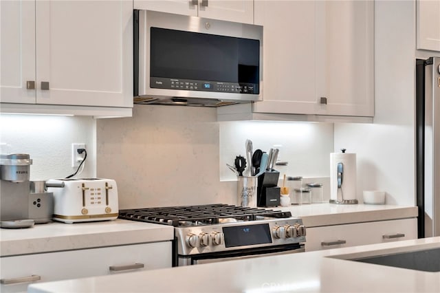 142 Juniper Dr, Rancho Mission Viejo, CA 92694 - kitchen featuring appliances with stainless steel finishes, light countertops, white cabinets, and decorative backsplash