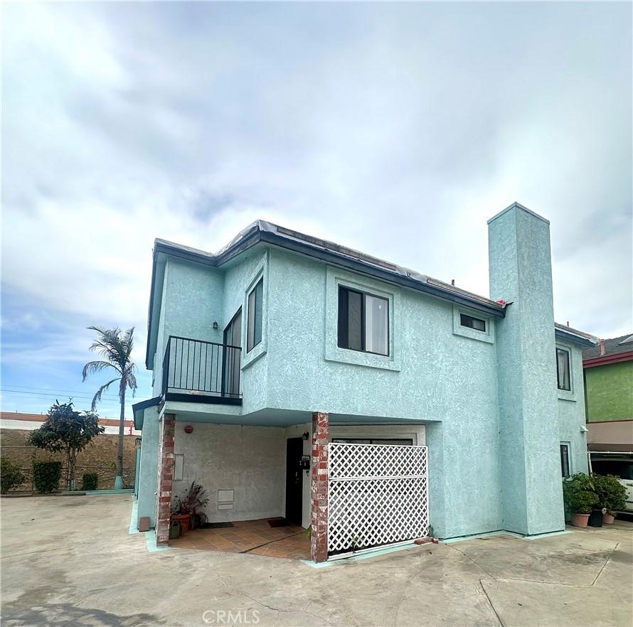 3748 W 118th St, Hawthorne, CA 90250 - rear view of property featuring an attached garage, a balcony, stucco siding, and a patio area