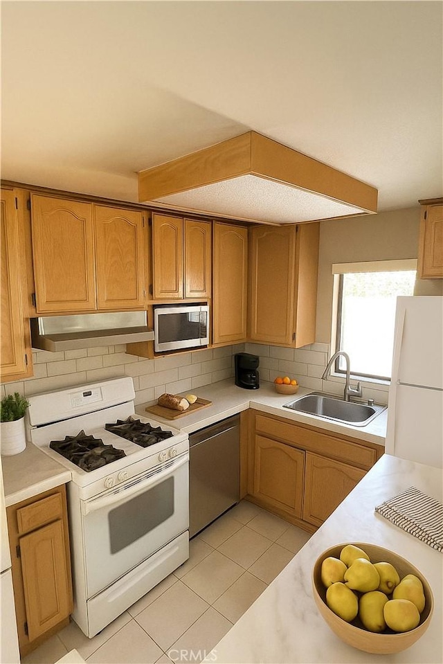 3748 W 118th St, Hawthorne, CA 90250 - kitchen featuring stainless steel appliances, light countertops, tasteful backsplash, under cabinet range hood, and light tile patterned floors