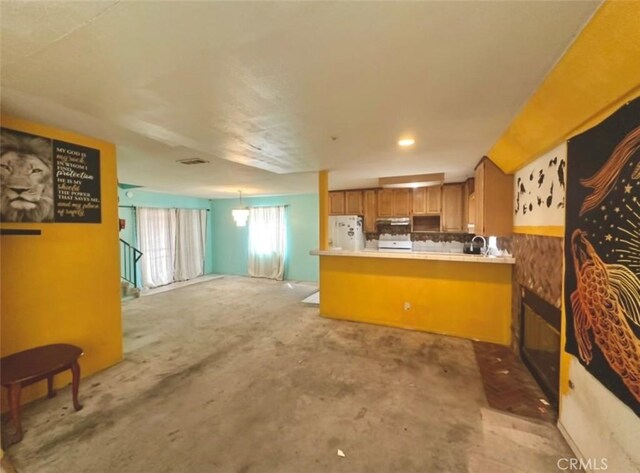 3748 W 118th St, Hawthorne, CA 90250 - kitchen with freestanding refrigerator, brown cabinets, open floor plan, a peninsula, and stove