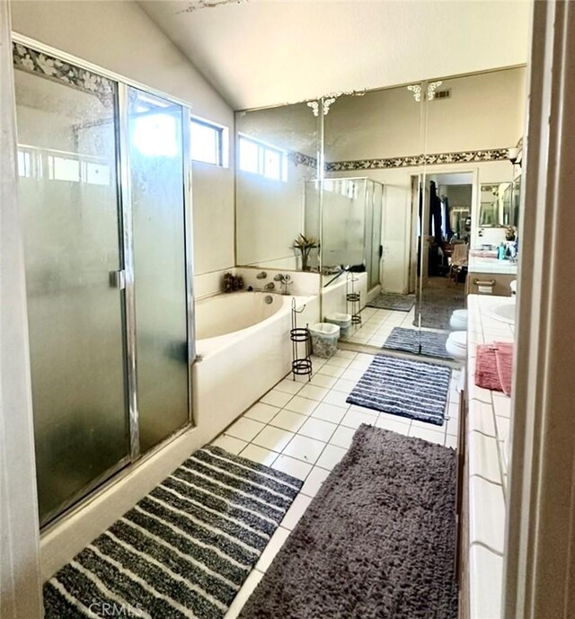 3748 W 118th St, Hawthorne, CA 90250 - bathroom featuring vanity, vaulted ceiling, a bath, a stall shower, and tile patterned flooring
