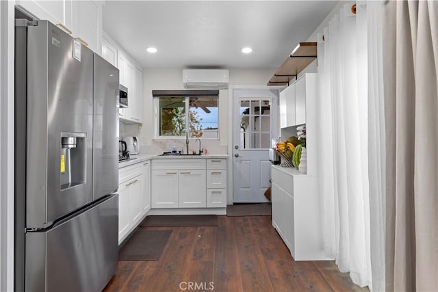 5911 Jones Ave, Westminster, CA 92683 - kitchen with stainless steel appliances, a wall mounted AC, light countertops, white cabinets, and dark wood finished floors