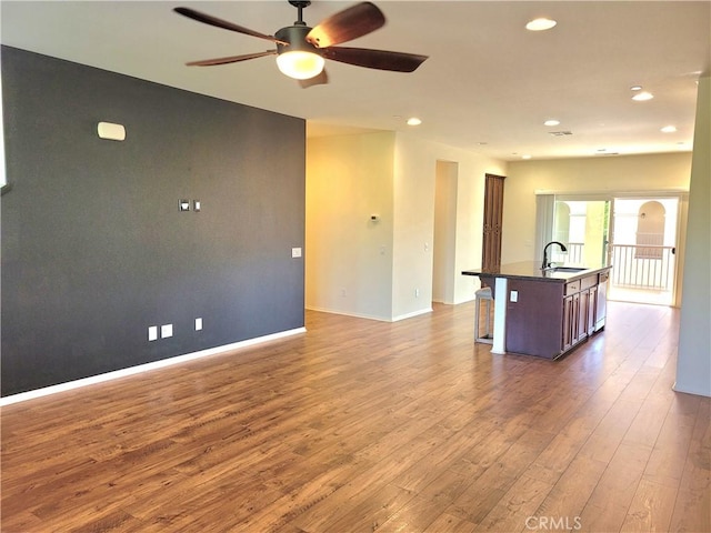 40955 Belleray Ave, Murrieta, CA 92562 - unfurnished living room featuring ceiling fan, a sink, dark wood-style flooring, recessed lighting, and baseboards