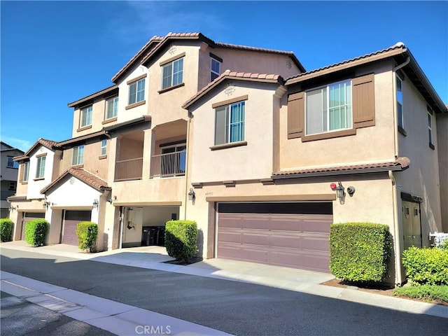 40955 Belleray Ave, Murrieta, CA 92562 - view of property with a garage, a tile roof, and stucco siding