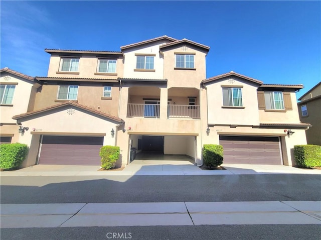 40955 Belleray Ave, Murrieta, CA 92562 - view of front facade with a garage, stucco siding, a tiled roof, and driveway