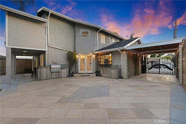 6612 Karin Pl, San Gabriel, CA 91775 - back of house at dusk with area for grilling, french doors, a patio, and a gate