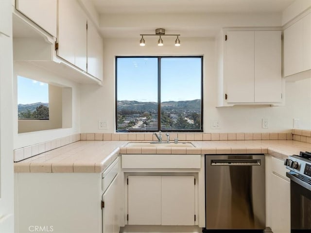 1311 15th St, Los Osos, CA 93402 - kitchen featuring appliances with stainless steel finishes, white cabinets, a mountain view, and tile countertops