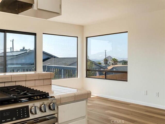 1311 15th St, Los Osos, CA 93402 - kitchen featuring tile counters, stainless steel range with gas stovetop, and light wood-style floors