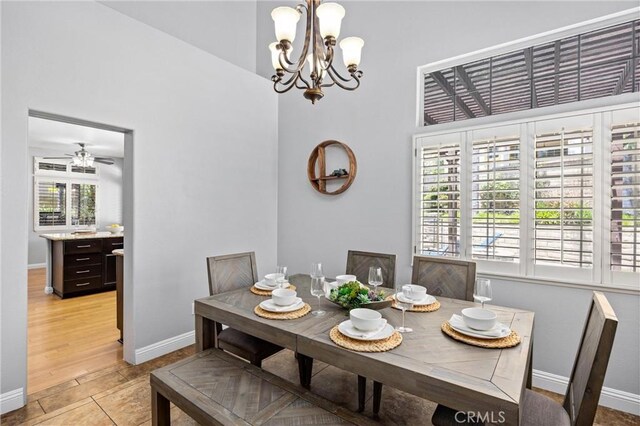 2300 Meadow View Ln, Chino Hills, CA 91709 - dining area with a chandelier, baseboards, a towering ceiling, and light tile patterned floors