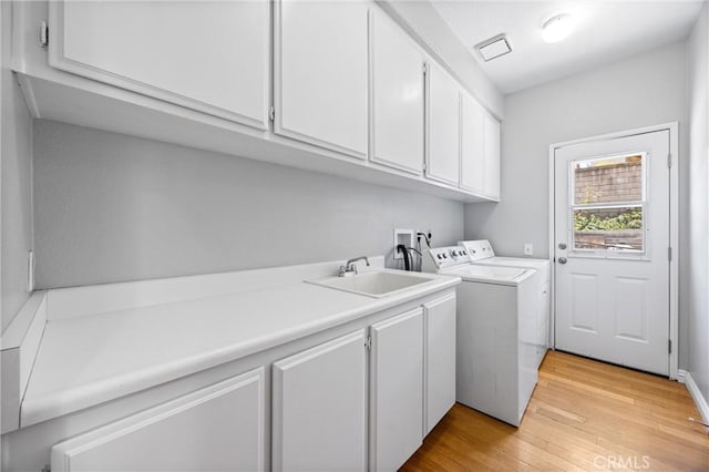 2300 Meadow View Ln, Chino Hills, CA 91709 - washroom featuring cabinet space, washing machine and clothes dryer, and light wood-style flooring