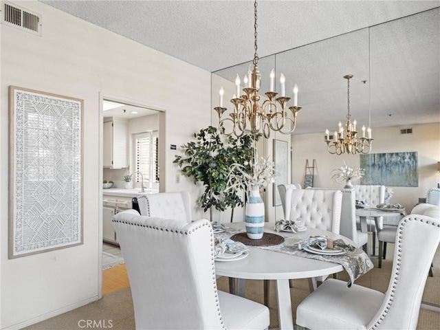 2563 Plaza Del Amo Unit 312, Torrance, CA 90503 - dining space featuring a chandelier, light colored carpet, and baseboards