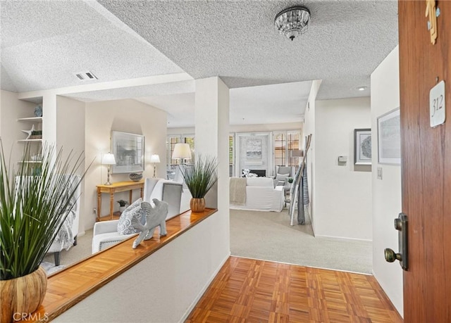 2563 Plaza Del Amo Unit 312, Torrance, CA 90503 - hallway featuring a textured ceiling, carpet flooring, and baseboards